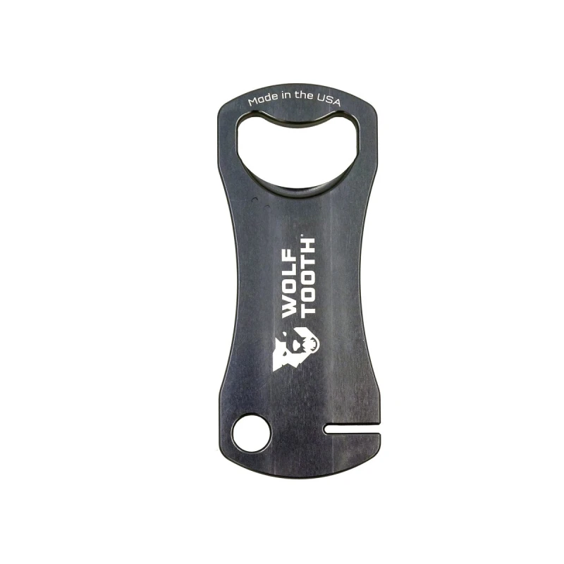 Szary klucz Wolf Tooth Components do prostowania tarcz hamulcowych z funkcją otwieracza do butelek.